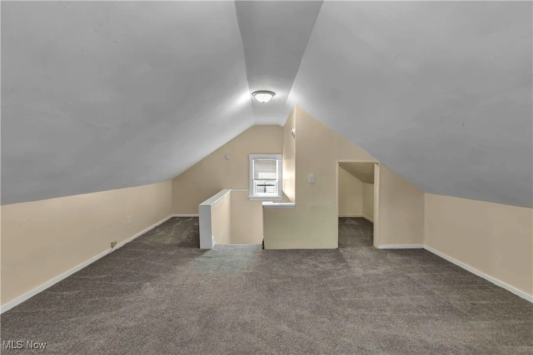 Bonus room featuring carpet flooring and vaulted ceiling