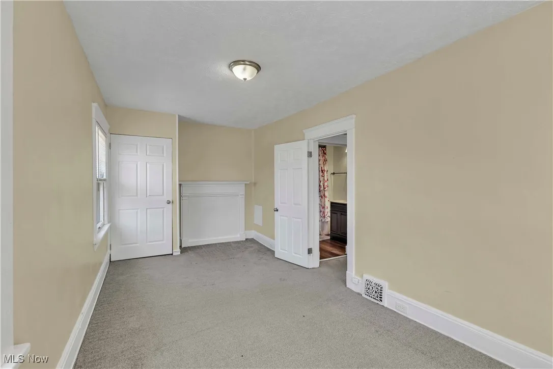 Unfurnished bedroom with carpet and baseboards