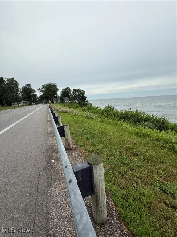 View of asphalt road with a water view