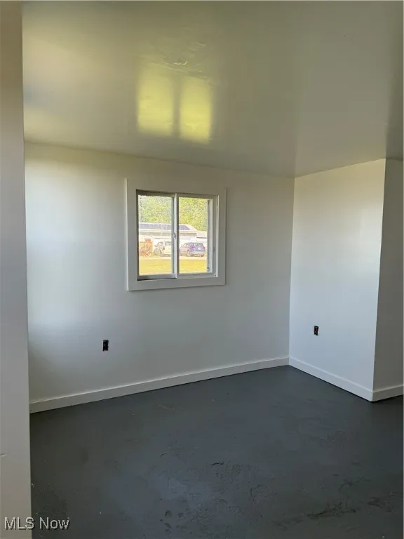 Unfurnished room with concrete floors