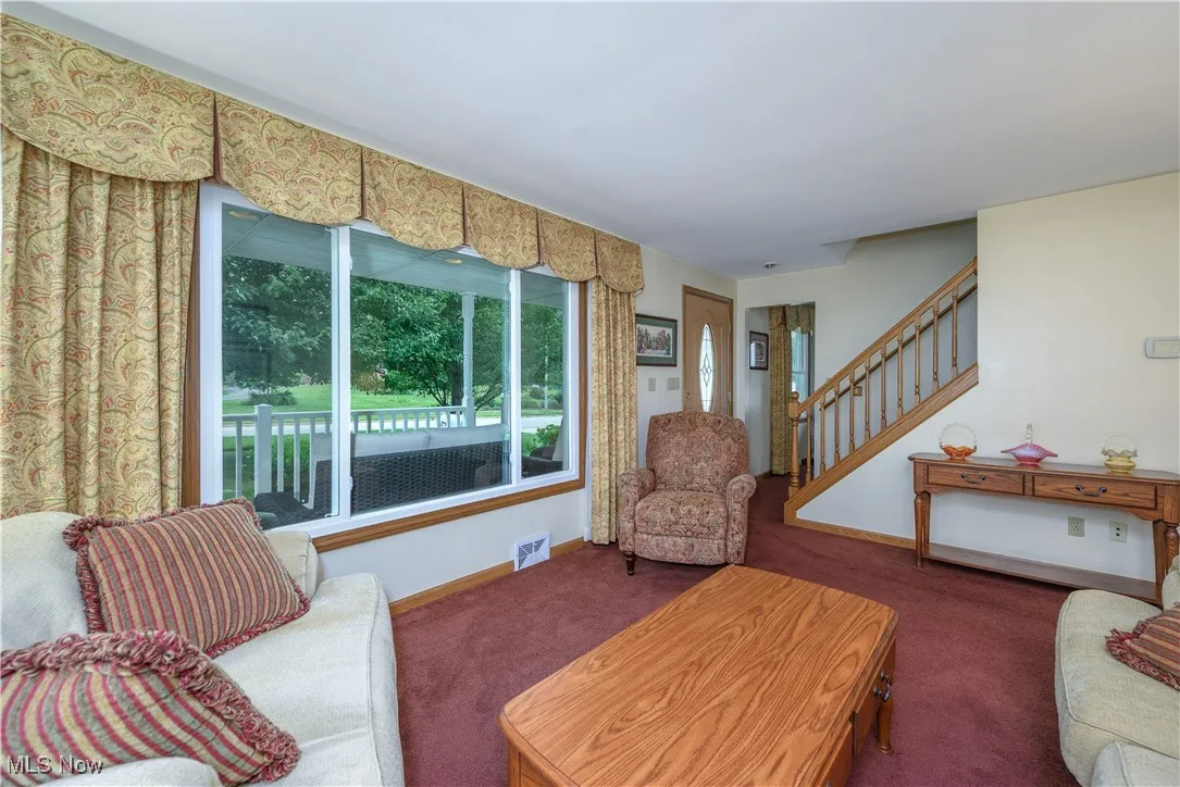 Living room with carpet and stairway