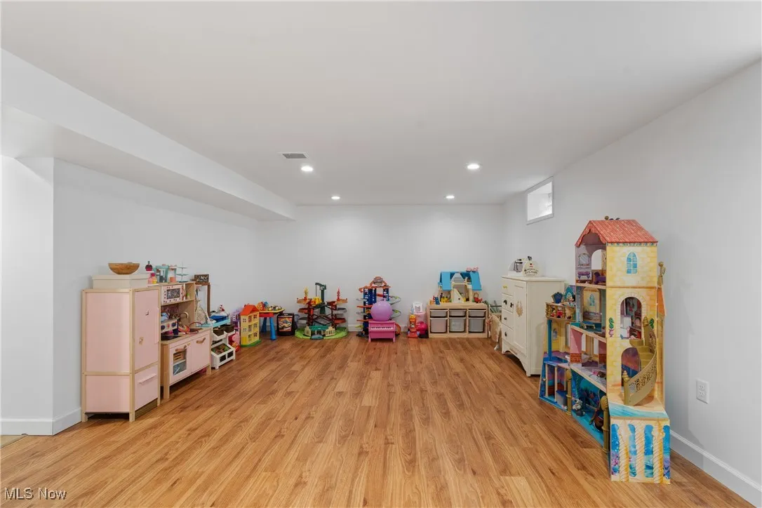 Playroom with light wood-style floors and recessed lighting