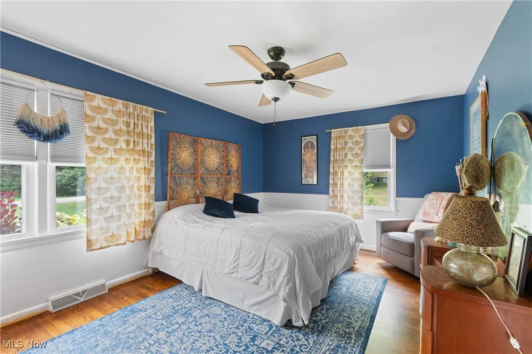 Bedroom with wood finished floors and ceiling fan