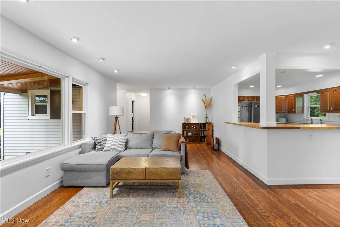 Living area with wood finished floors and recessed lighting