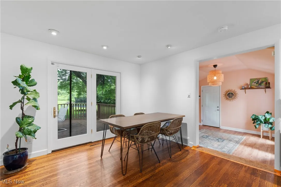 Dining area featuring wood finished floors, recessed lighting, and vaulted ceiling