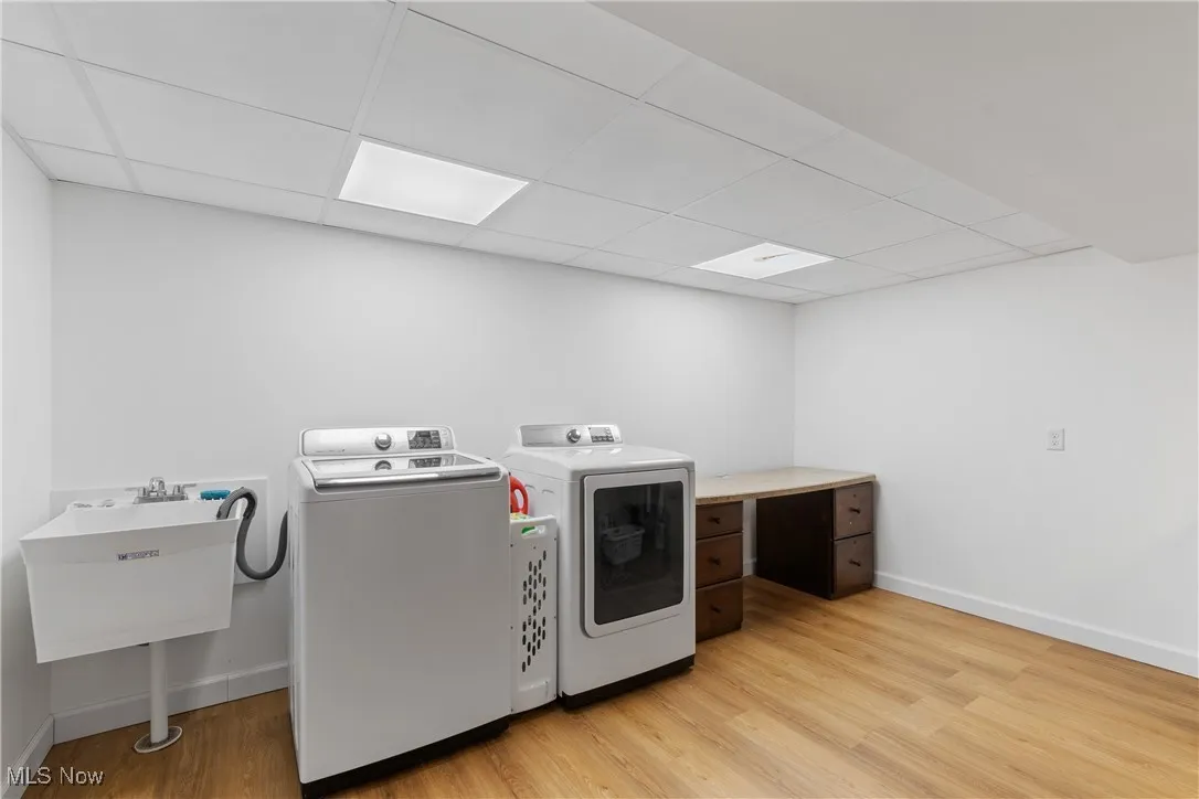 Laundry area featuring washing machine and dryer and light wood finished floors