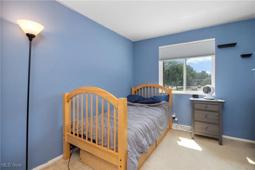 Carpeted bedroom featuring baseboards