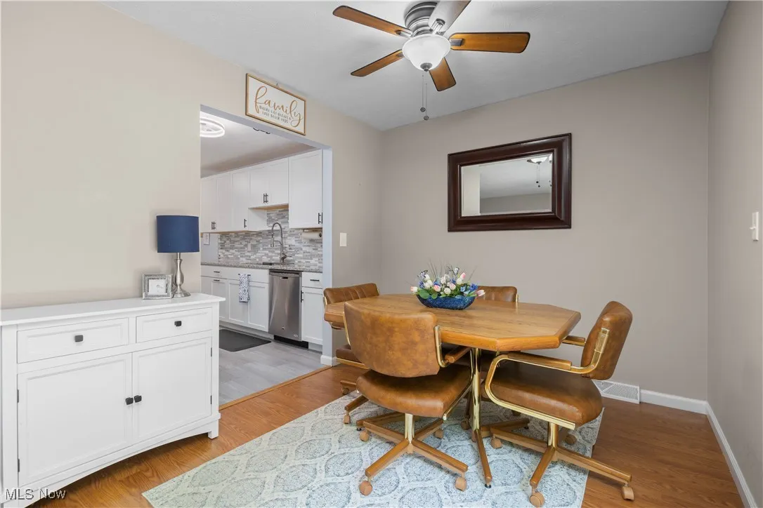 Dining room featuring a ceiling fan and light wood finished floors