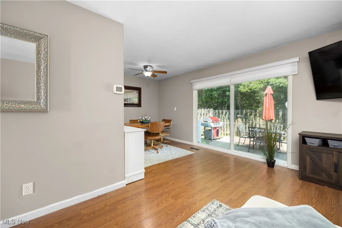 Living room featuring ceiling fan and wood finished floors