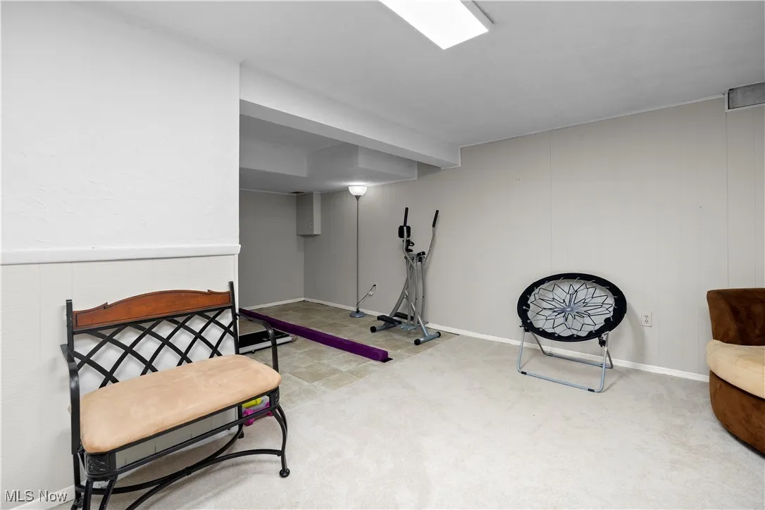 Exercise room with carpet and baseboards