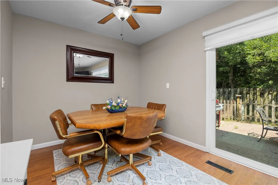 Dining room featuring a ceiling fan and wood finished floors