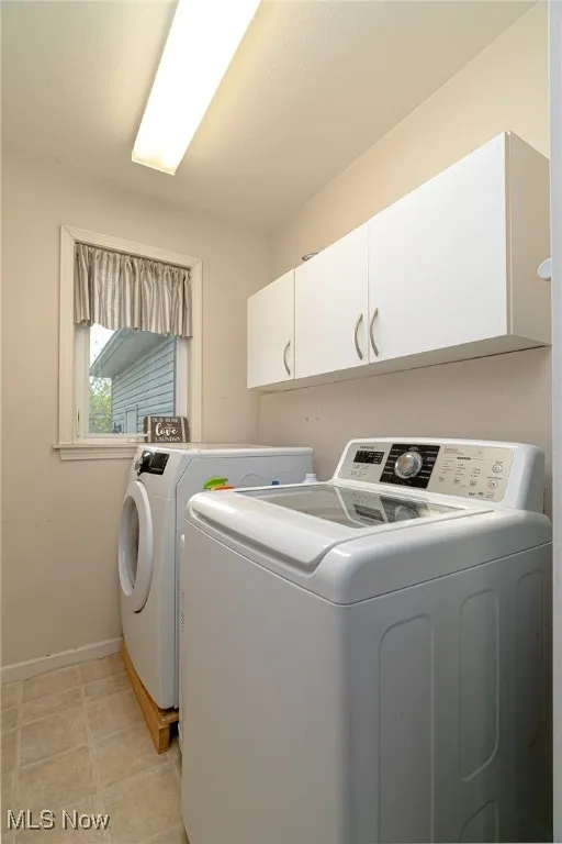 Laundry room featuring cabinet space and washer and dryer