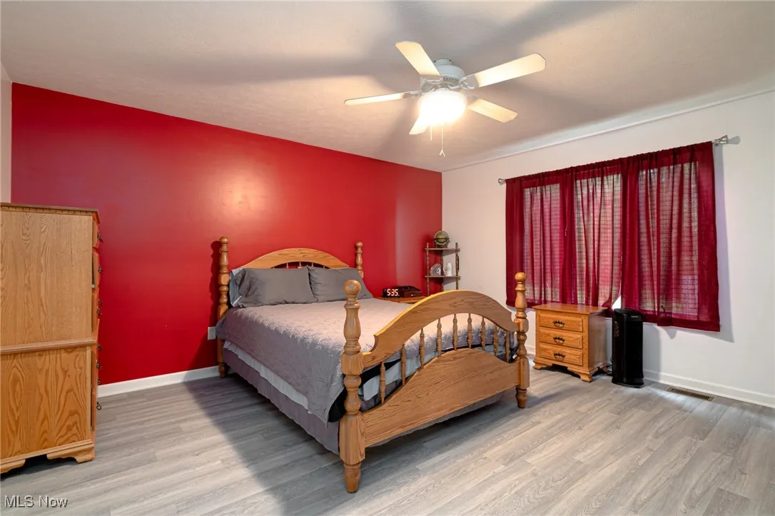 Bedroom with wood finished floors and ceiling fan