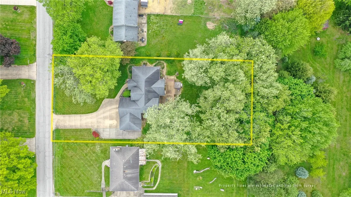 Aerial view of property and surrounding area featuring property parcel outlined