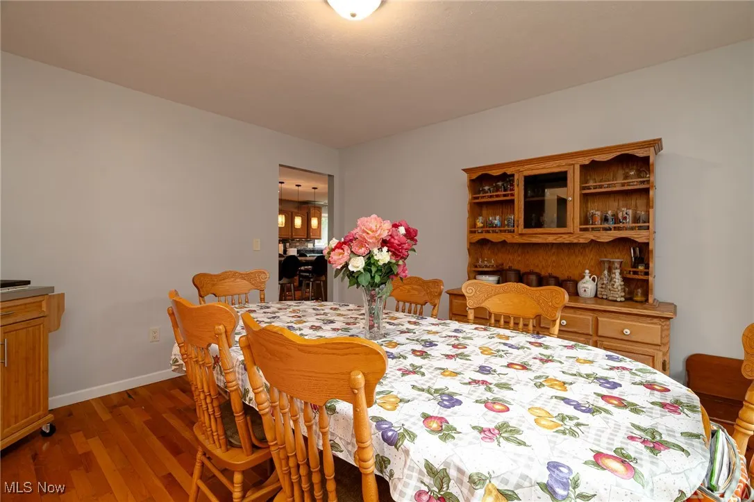 Dining space featuring wood finished floors and baseboards