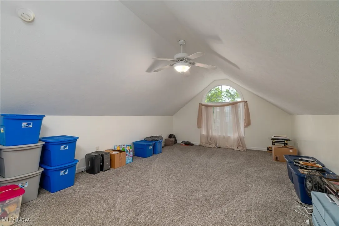 Bonus room featuring lofted ceiling, carpet flooring, and ceiling fan