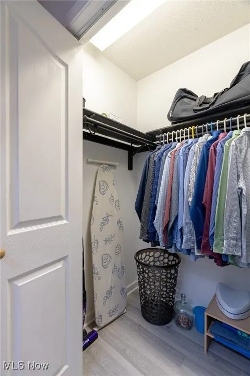 Spacious closet featuring wood finished floors