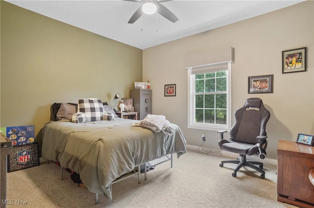 Bedroom with carpet and a ceiling fan