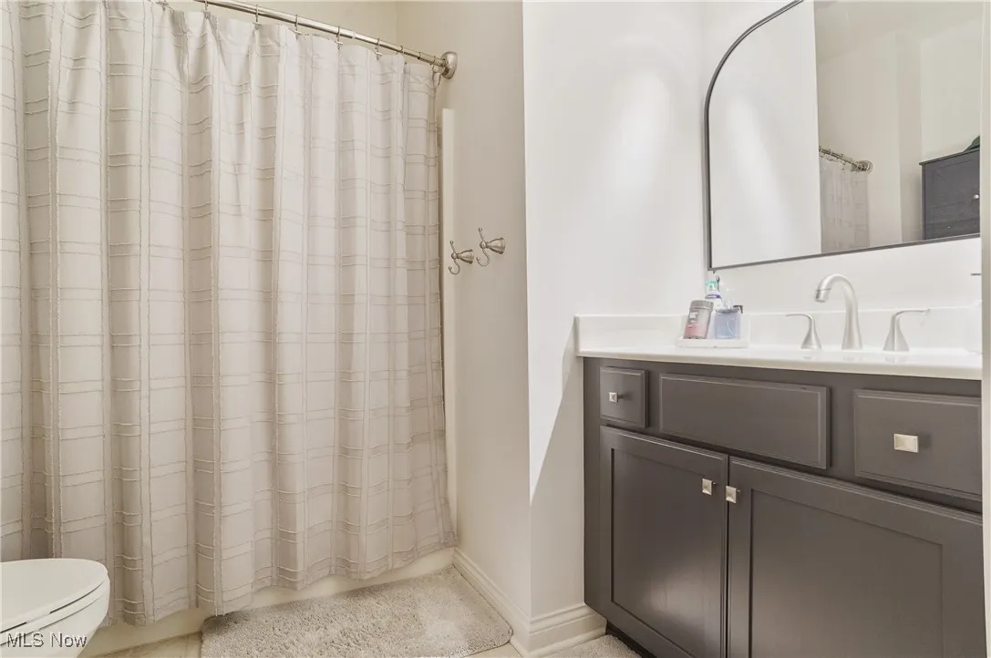 Bathroom with vanity and a shower with shower curtain