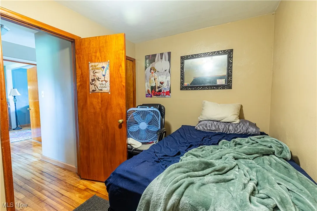 Bedroom featuring hardwood / wood-style floors and baseboards