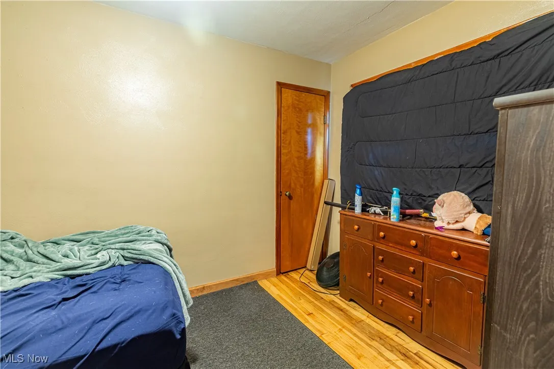 Bedroom with light wood-style flooring and baseboards
