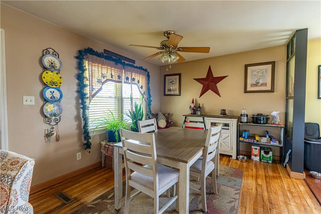 Dining area featuring ceiling fan and light wood-style flooring