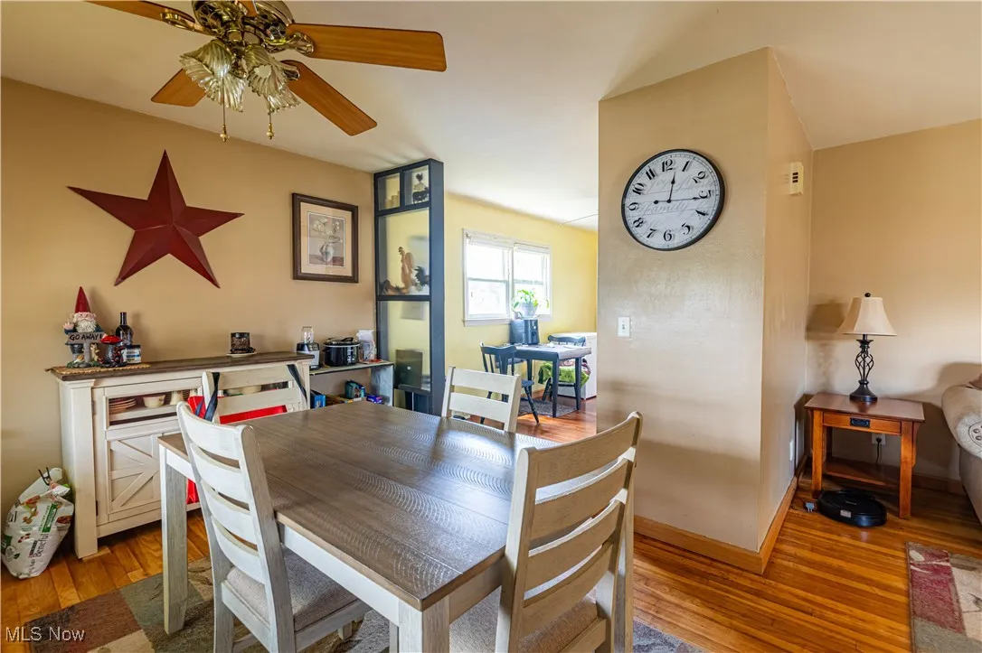 Dining room with wood finished floors and ceiling fan