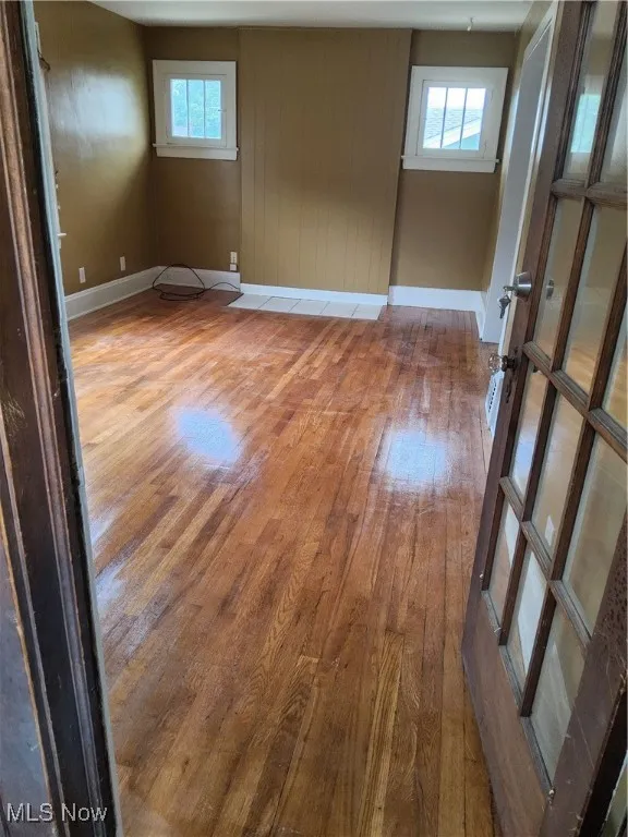 Spare room with hardwood / wood-style floors and baseboards