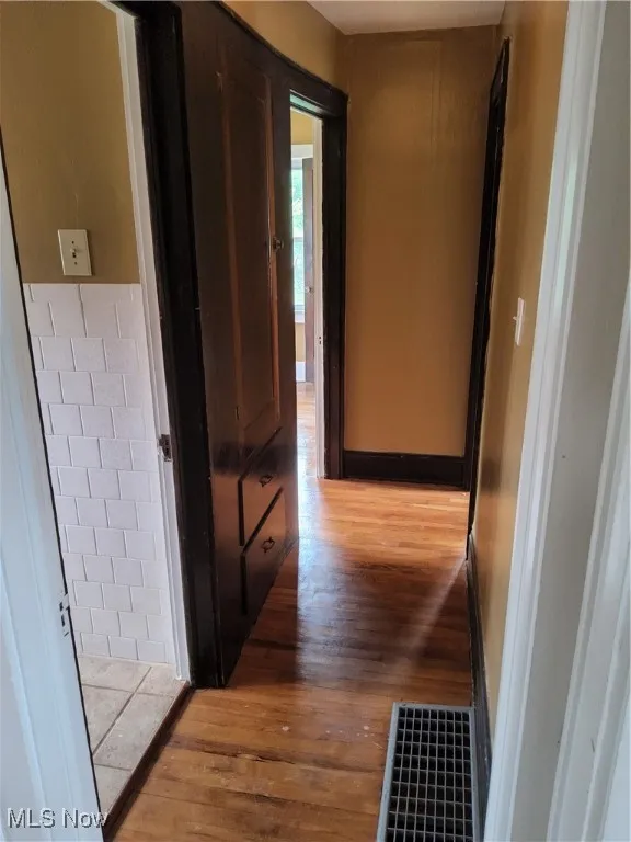 Hallway with light wood-type flooring
