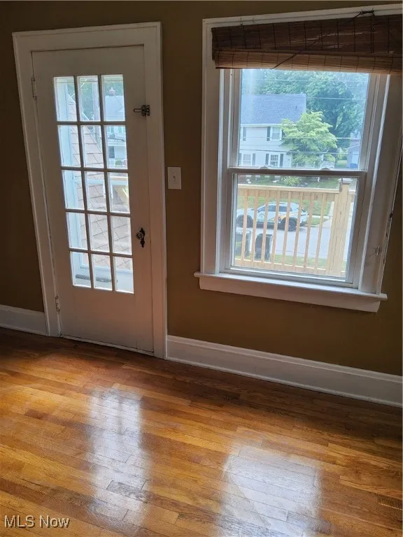 Entryway with wood finished floors and baseboards