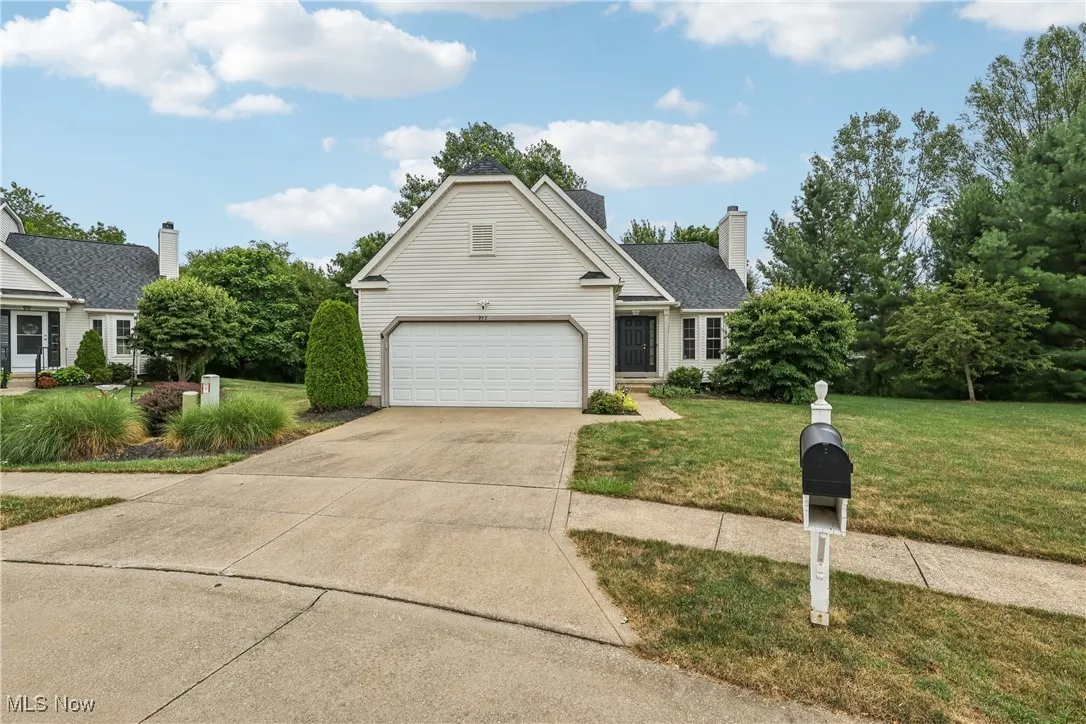 Front of the freestanding condo with a front yard and 2 car attached garage.