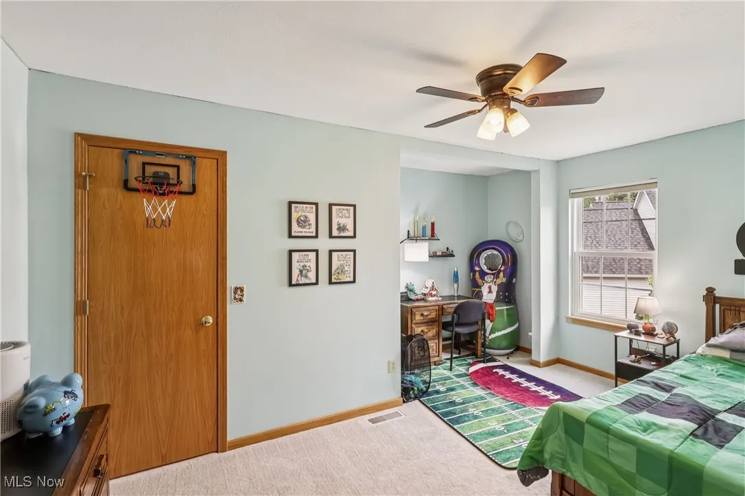 Bedroom with a closet, ceiling fan / light and carpet flooring