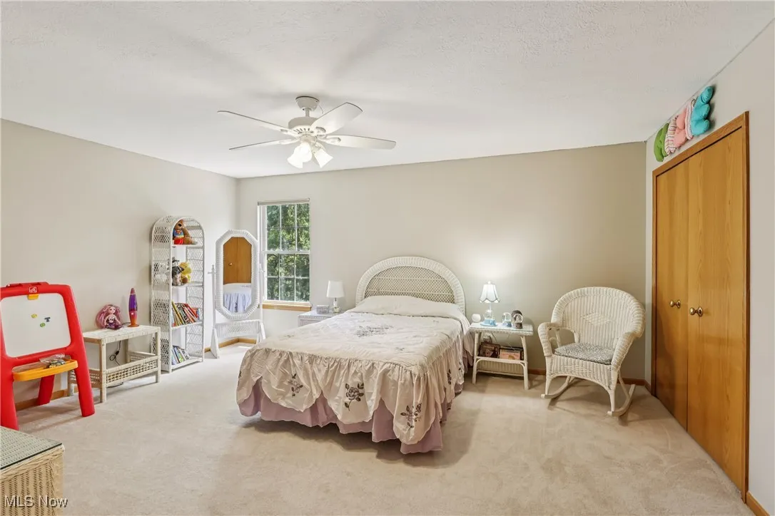 Bedroom with closet, ceiling fan / light and carpet flooring