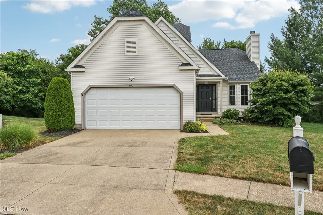 Front of the freestanding condo with a front yard and 2 car attached garage.