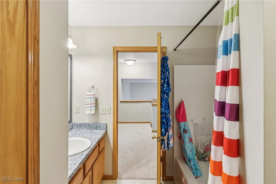 Another view of the second floor bathroom with sink, vanity and shower / tub combo