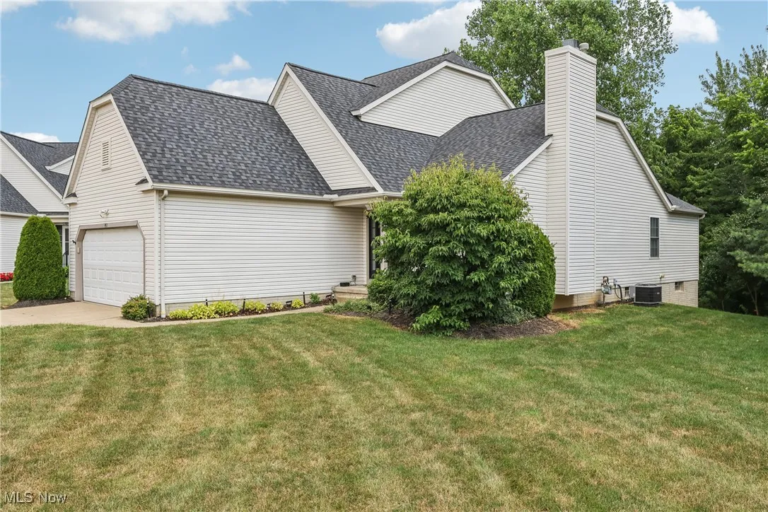 View of other side of the property with a yard