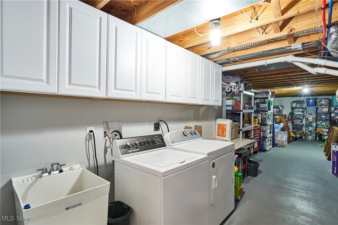 Laundry room featuring cabinet space and washing machine and dryer