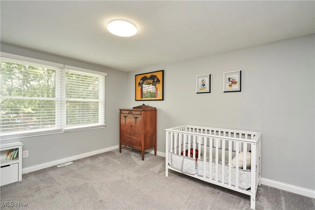 Carpeted bedroom with baseboards