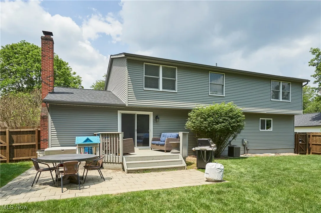 Back of house with a patio, a chimney, an outdoor hangout area, and a wooden deck
