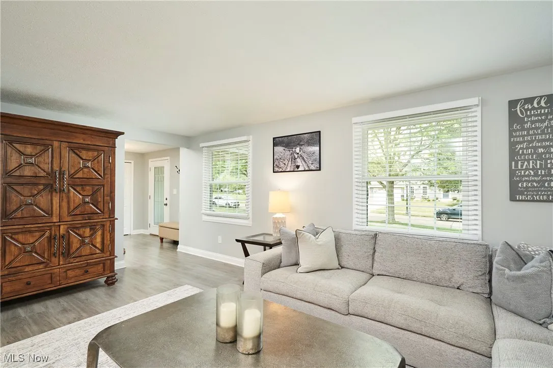 Living area with wood finished floors and baseboards