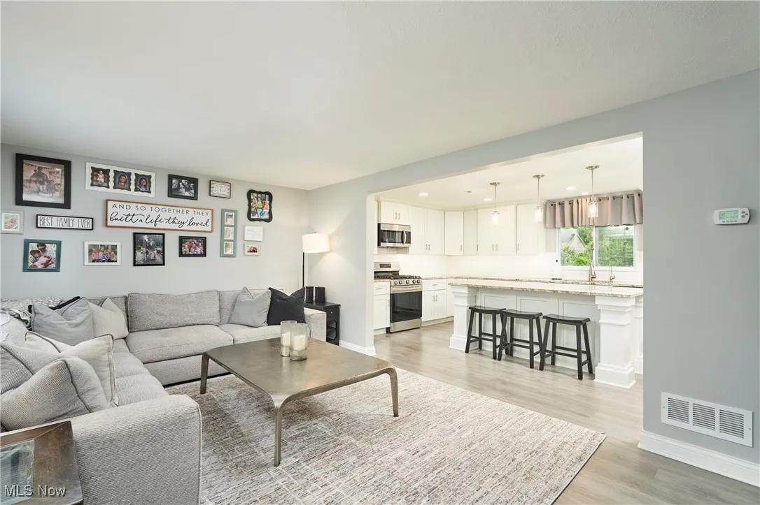 Living area with light wood-type flooring and baseboards