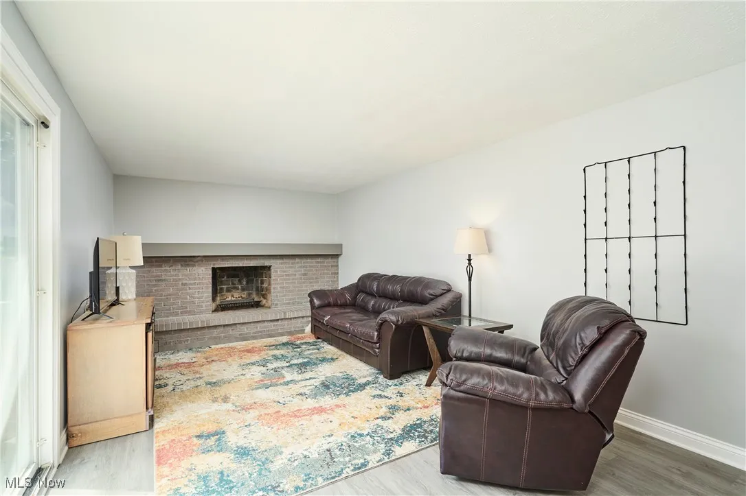 Living area with wood finished floors and a fireplace