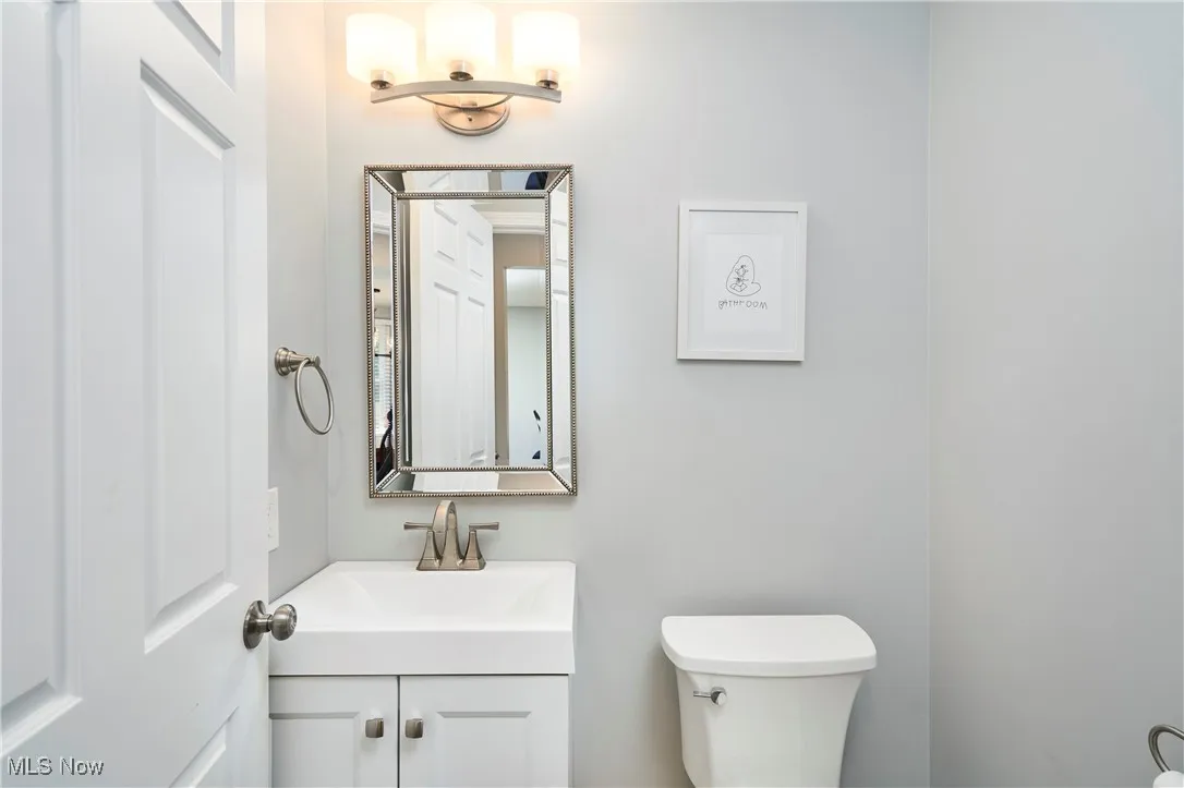 Half bathroom with vanity and toilet