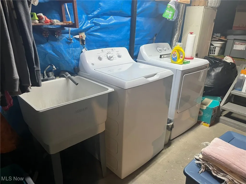 Laundry area featuring washer and clothes dryer and water heater