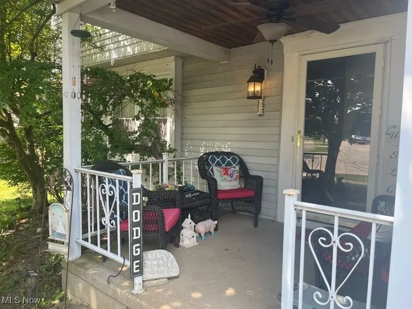 Covered porch featuring ceiling fan
