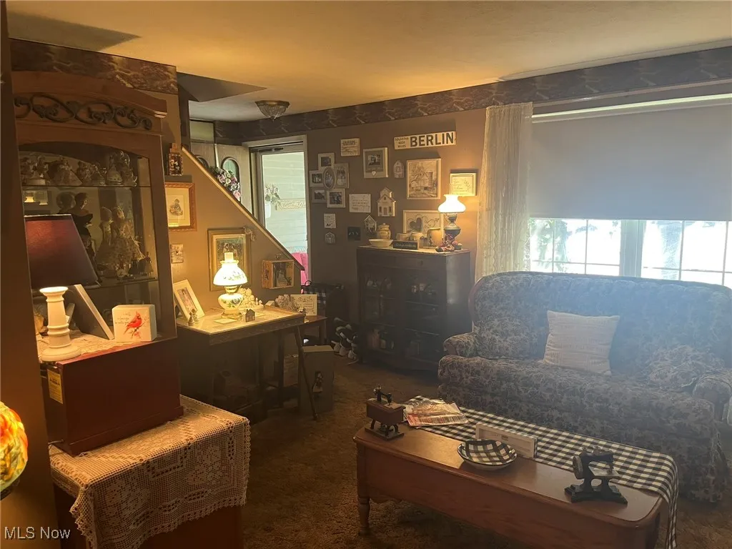 Carpeted living room with plenty of natural light