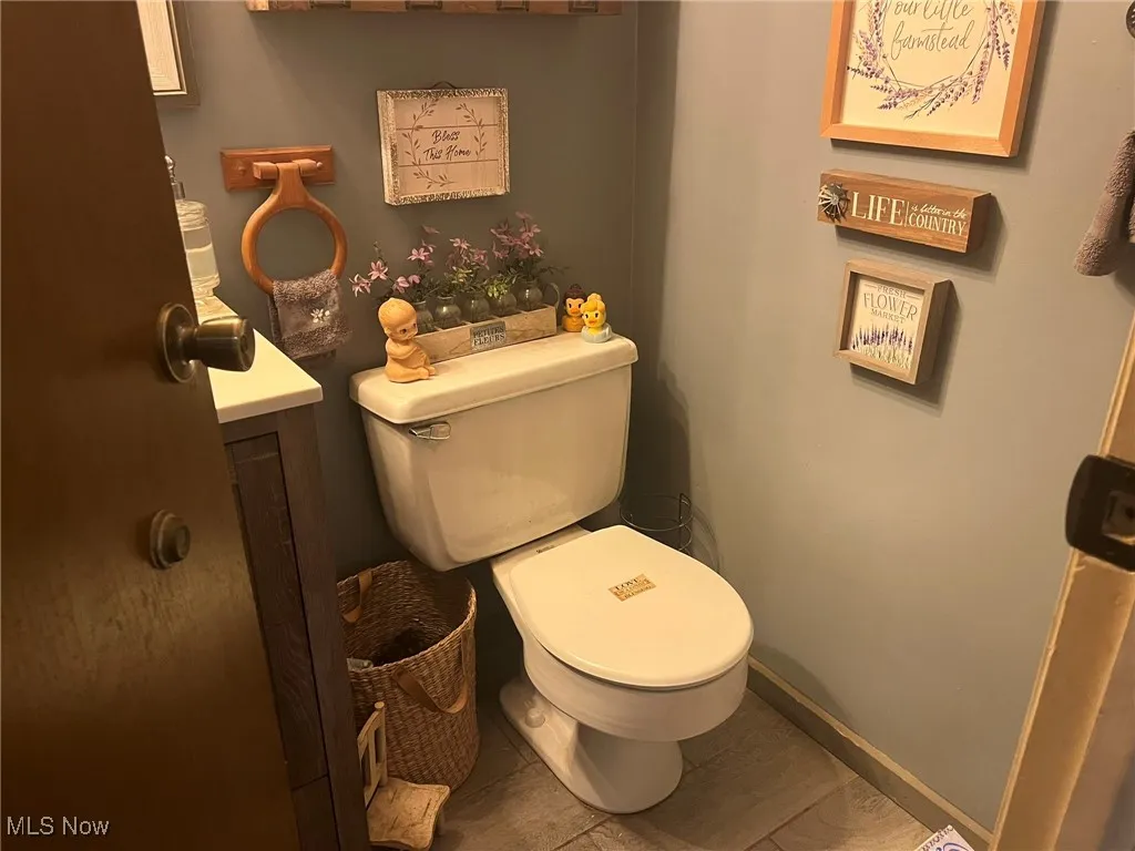 Half bathroom featuring toilet and vanity