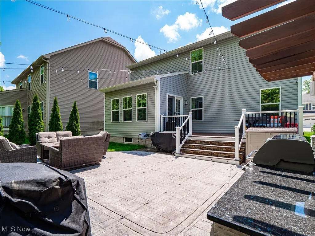 Rear view of house featuring an outdoor hangout area, a patio, and a wooden deck