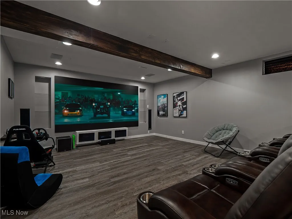 Home theater room featuring beamed ceiling, wood finished floors, and recessed lighting
