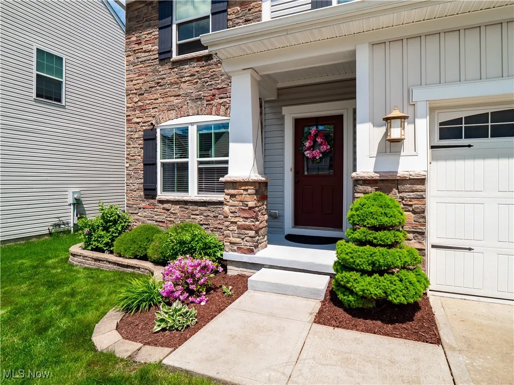 View of exterior entry featuring stone siding and board and batten siding